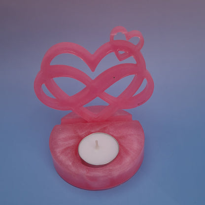 Castiçal em resina epóxi rosa perolado com formato de coração infinito e suporte para vela tealight, vista superior