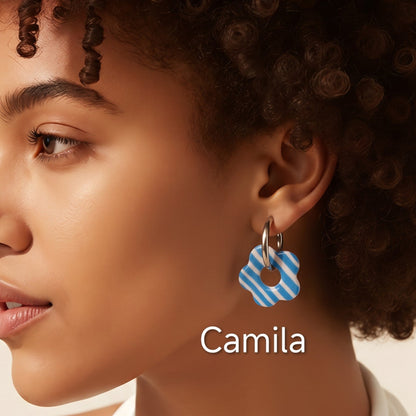 Brincos intercambiáveis Sweet Art com pendentes Camila em argila polimérica azul e branca às riscas, usados com argolas.